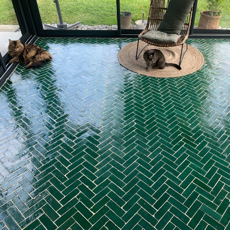 Green bejmat zellige laid in herringbone around a pool