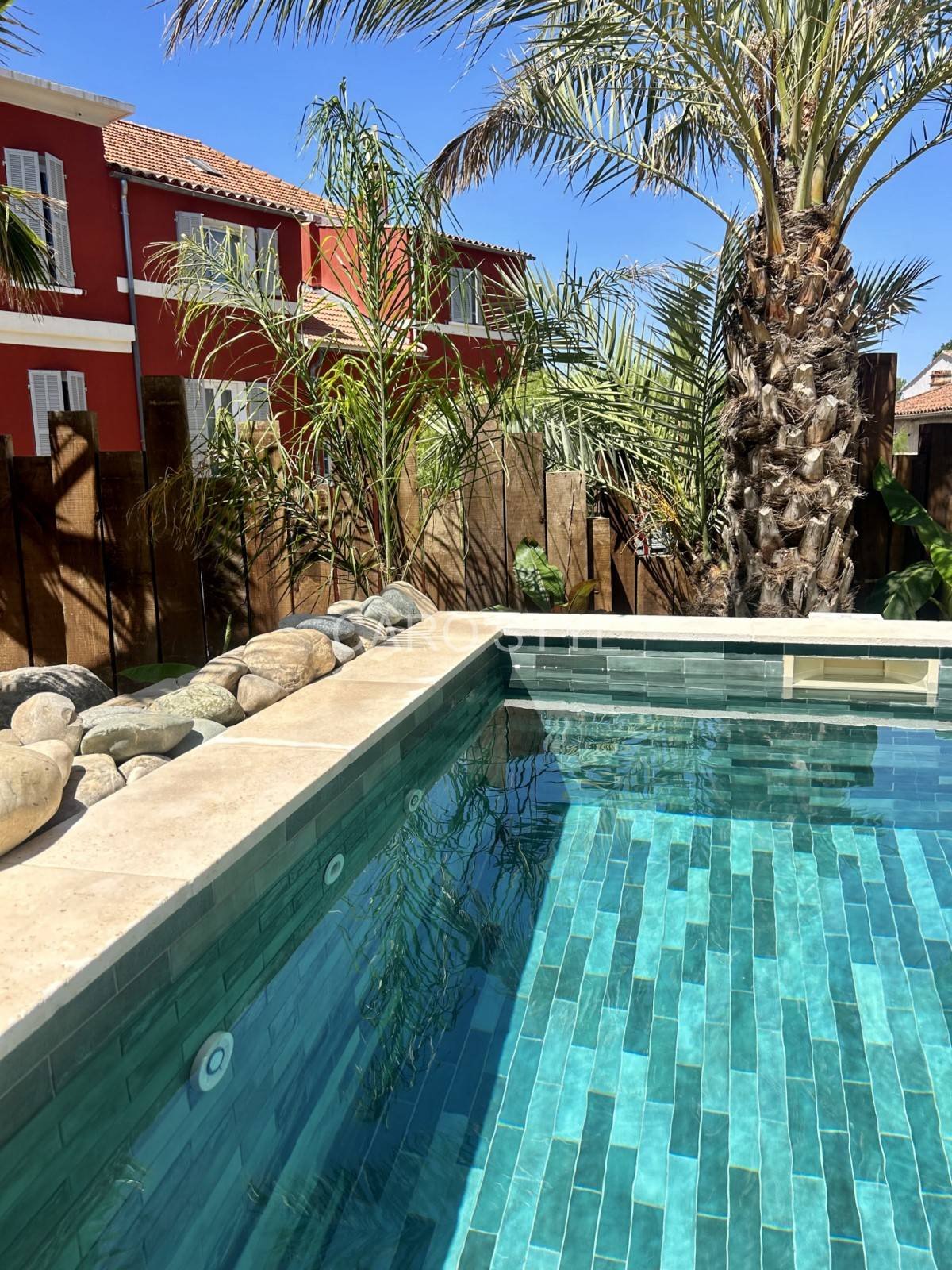 Pool terrace lined with teal turquoise zellige tiles